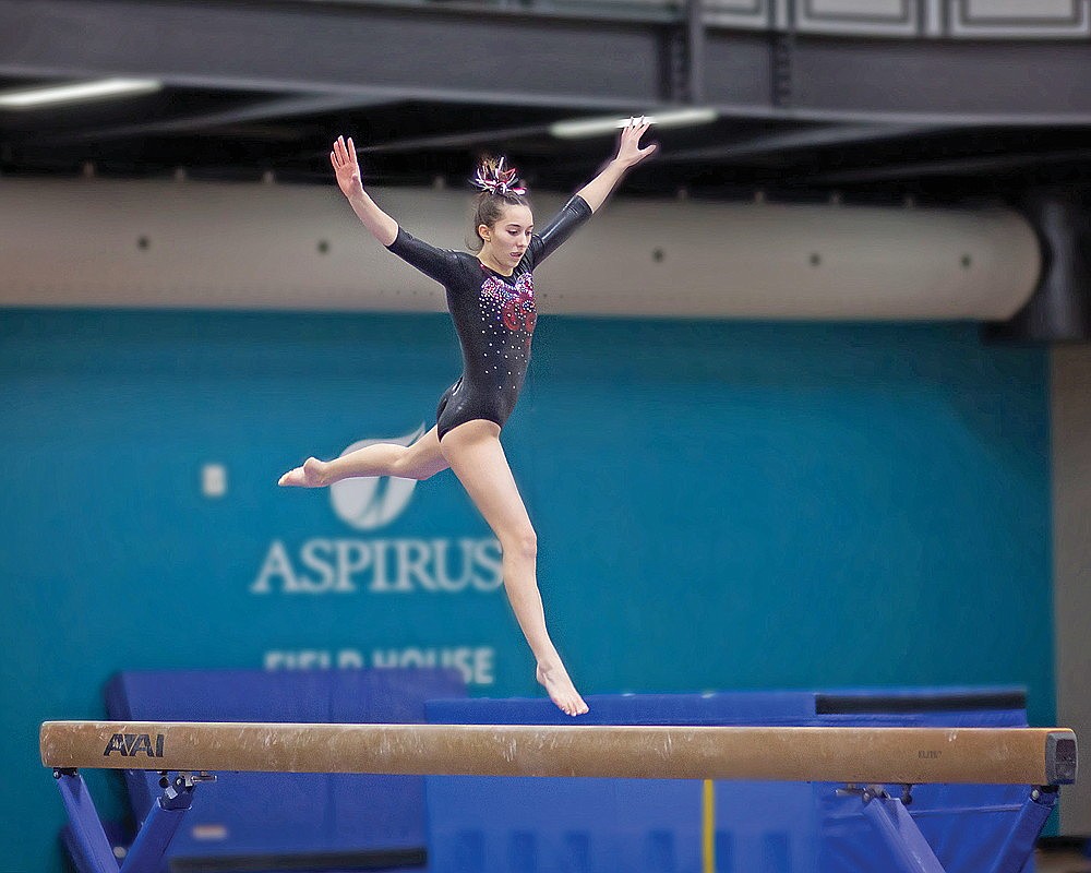 Alexis Smith performs a jump on the balance beam during the Starlight Invitational club meet in Wausau Friday, Jan. 10. (Nicole Smith/submitted)