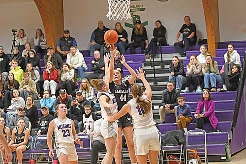 Kristina Ouimette attempts a jump shot contested by Mosinee’s Britt Fitzgerald, left, and Bridget Frye in the second half of a conference game Friday, Jan. 17 at Mosinee High School. Ouimette led all scorers with 28 points. (Photo by Brett LaBore/Lakeland Times)
