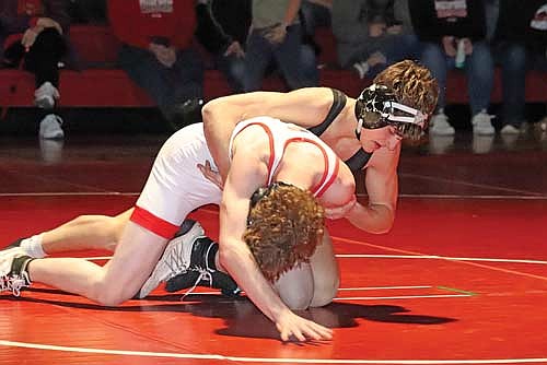 Charlie Ernst grabs ahold of Medford’s Corey McVicker in the 132-pound weight class during the conference opener Thursday, Jan. 16 at Raider Hall in Medford. Ernst picked up a pin in 2:30. (Photo by Matt Frey/Star News)