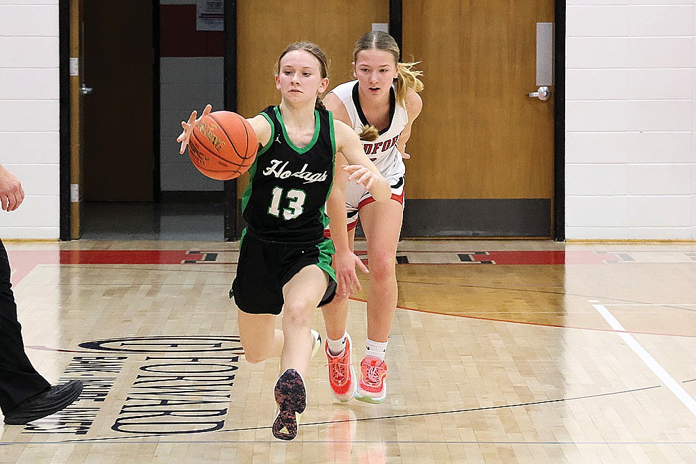 Rhinelander’s Ellie Cummings tries to track down a loose ball, chased by Medford’s Rylee Hraby during the first half of a GNC girls’ basketball game at Medford Friday, Jan. 17. The Hodags, without leading scorer Aubryn Clark for a second straight game, fell to the Raiders, 64-56. (Matt Frey/Star News)