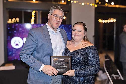 Family friend Ryan Hetland, left, accepted the Legacy Award, presented by chamber executive director Lauren Sackett, during the annual Chamber Awards Gala and Fundraiser Thursday, Jan. 23, 2025. (Photo courtesy of Amanda Anderson Photography)