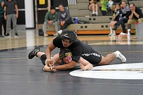 Tyrone Moore, top, wrestles against Tomahawk’s Nathan Norman in the 285-pound weight class during a conference quad Thursday, Jan. 30 at the Lakeland Union High School fieldhouse in Minocqua. Moore pinned Norman in 3:37. (Photo by Brett LaBore/Lakeland Times)