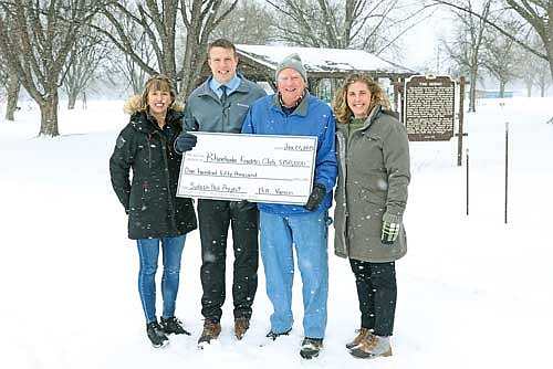 Kiwanis members Stephanie Dahlquist, Brandon Karaba and club president Sandy Klima accept a donation of $150,000 from Bill Vancos (second from right) to the club’s fundraising campaign to add a splash pad and upgraded playground to Hodag Park. (Photo by Bob Mainhardt for the River News)