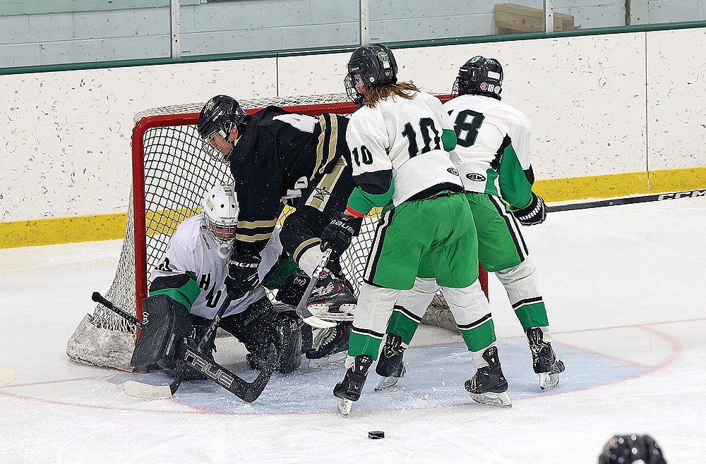 Rhinelander goaltender Asher Rivord tries to go after the puck with Lakeland’s Dom Gironella and Rhinelander’s Riley Squires and Van Tulowitzky in the crease during the second period of a GNC boys’ hockey game at the Rhinelander Ice Arena Thursday, Jan. 30. (Bob Mainhardt for the River News)