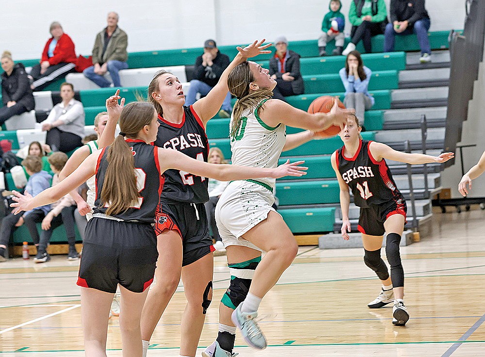 Rhinelander’s Kelsey Winter puts up a shot against Stevens Point’s Lindsey Weiler (24) and Jacinta Zdroik (12) during the second half of a non-conference girls’ basketball game at the Jim Miazga Community Gymnasium Tuesday, Feb. 4. The Hodags lost, 54-38. (Bob Mainhardt for the River News)