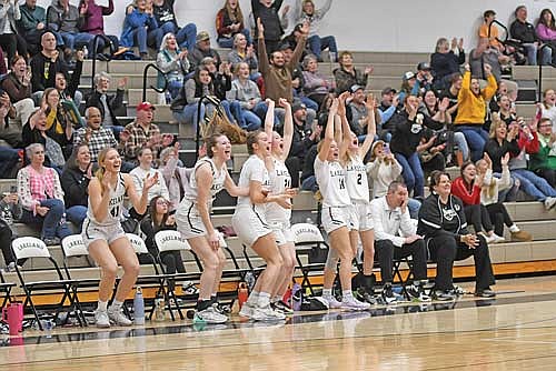 Lakeland players, from left, Saylor Timmerman, Ava Evenhouse, Kristina Ouimette, Cale Quade, Ali Timmerman and Bobbi Lee celebrate on the bench after scoring their 100th point in the second half against Northland Pines Friday, Feb. 7 at Ted Voigt Court in Minocqua. The 100 points set a new school record for most points scored in a game. (Photo by Brett LaBore/Lakeland Times)