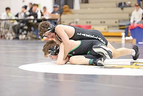 Charlie Ernst, top, gets in position against Rhinelander’s Ivan Loka during the Great Northern Conference Meet Saturday, Feb. 8 at the Lakeland Union High School fieldhouse in Minocqua. Ernst ended up in second place in the 126-pound weight class. (Photo by Bob Mainhardt for the River News)