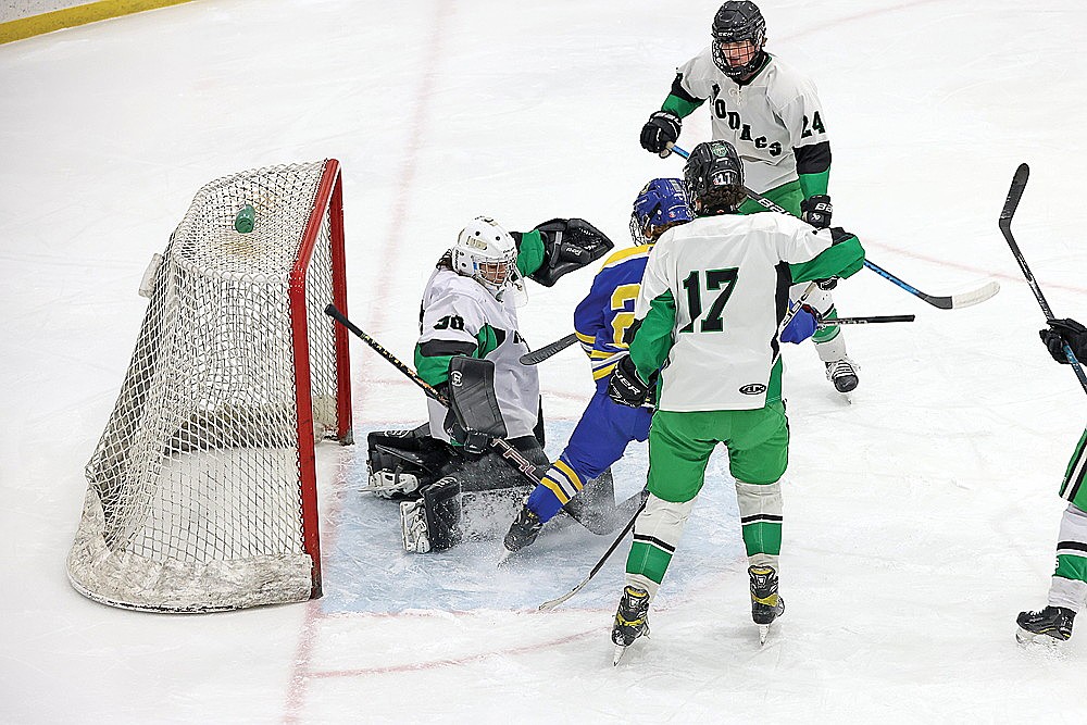 Rhinelander’s Asher Rivord makes a save in front of Kingsford’s Jake Crockford during the first period of a non-conference boys’ hockey game at the Rhinelander Ice Arena Thursday, Feb. 6. Rivord made 46 saves in back-to-back games as Rhinelander lost to Kingsford and Ashland by matching 4-0 scores. (Bob Mainhardt for the River News)