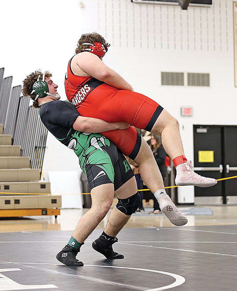 Rhinelander’s Reid Schultz lifts Medford’s Forest Hartl off the mat in a 285-pound match at the GNC wrestling tournament in Minocqua Saturday, Feb. 8. Schultz pinned all four of his opponents Saturday en route to a second straight GNC championship in the weight class. (Bob Mainhardt for the River News)