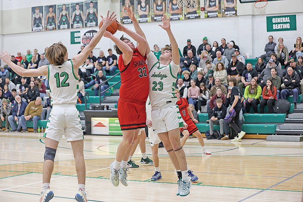 Rhinelander’s Evan Shoeder (23) and Truman Lamers (12) attempt to block a shot by Shawnao’s Crew Weisnicht during the first half of a non-conference boys’ basketball game at the Jim Miazga Community Gymnasium Tuesday, Feb. 11. The Hodags limited the Hawks to 31 shot attempts and forced 21 turnovers in a 49-34 victory. (Bob Mainhardt for the River News)