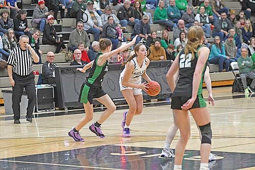 Savanah Kemnitz controls the ball guarded by Rhinelander’s Ava Kurilla in the second half of a 70-15 win Friday, Feb. 14 at Ted Voigt Court in Minocqua. (Photo by Brett LaBore/Lakeland Times)