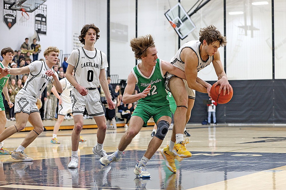 Rhinelander’s Truman Lamers battles Lakeland’s Noah Bruckner for a rebound during the second half of a GNC boys’ basketball game in Minocqua Friday, Feb. 14. Rhinelander fended off Lakeland 62-57 to remain in a first-place time in the conference. (Bob Mainhardt for the River News)