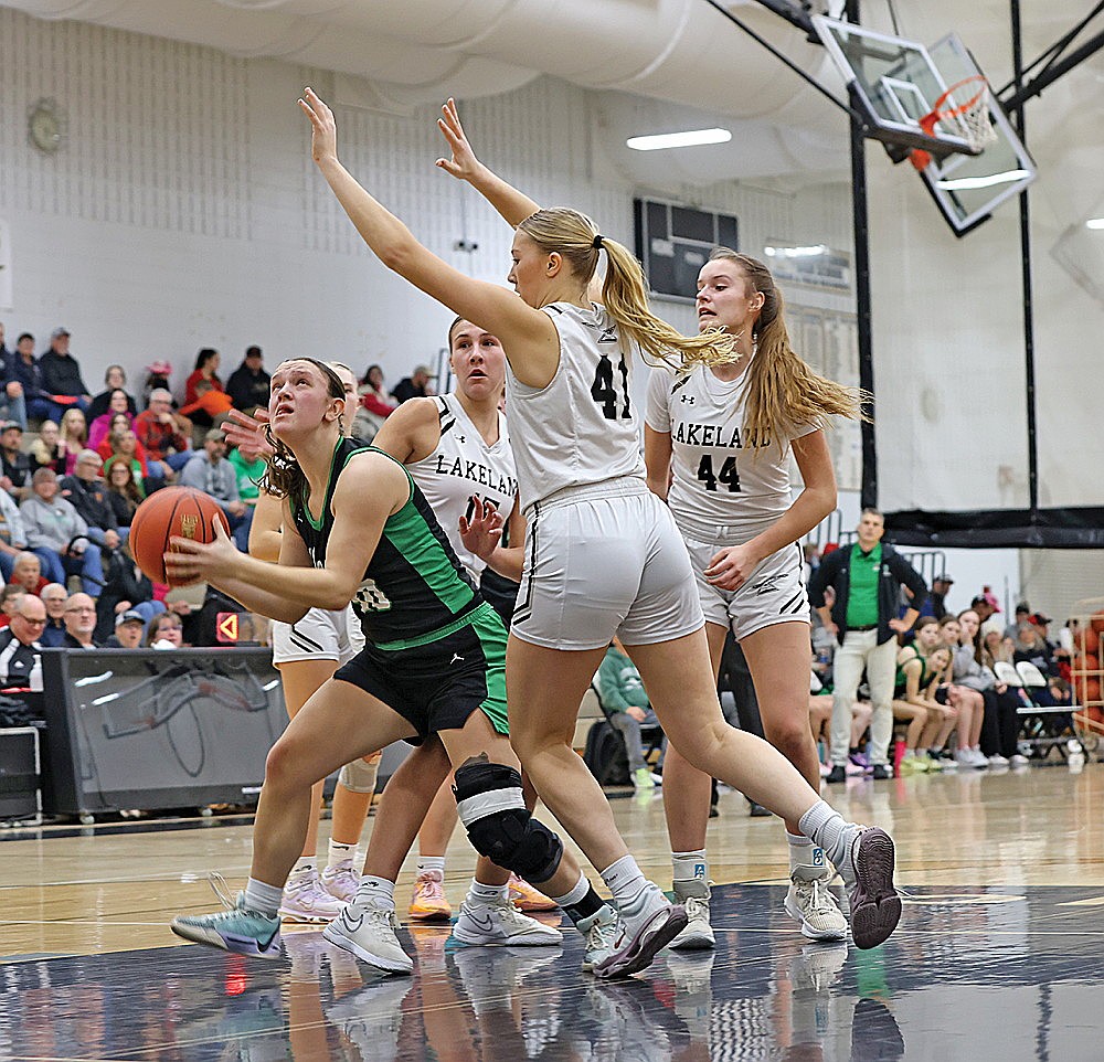 Rhinelander’s Kelsey Winter fights between Lakeland’s Alyssa Erickson (15), Kristina Ouimette (44) and Saylor Timmerman (41) for a shot attempt during the first half of a GNC girls’ basketball game in Minocqua Friday, Feb. 14. (Bob Mainhardt for the River News)