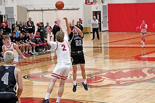 Alton Jackson attempts a 3-pointer against the contest of Shawano’s Logan Sipple in the second half of a non-conference game Tuesday, Feb. 18 at Shawano Community High School. (Photo by Brett LaBore/Lakeland Times)