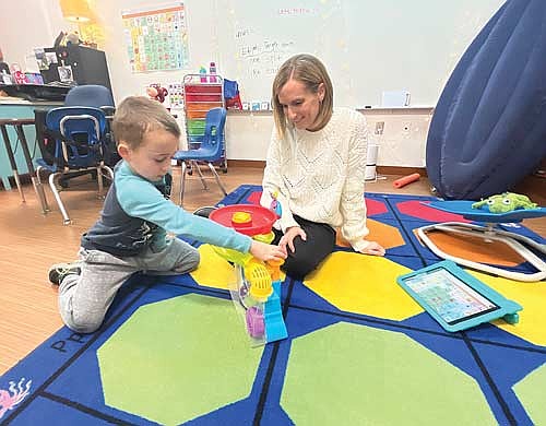 MHLT speech language pathologist Katy Zoch shows student Luca Rademacher a fun game on Tuesday, Feb. 28, in Minocqua. (Photo by Trevor Greene/Lakeland Times)