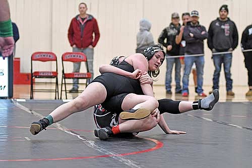 Siraelyn Peterson gets brought down by Pulaski’s Ellie Neosh in the 165-pound weight class during a WIAA sectional meet Friday, Feb. 21 at Shawano Community High School. (Photo by Brett LaBore/Lakeland Times)