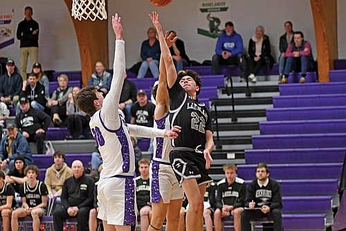 Alton Jackson places a shot over Mosinee’s Brayden Reinke in the second half of a conference game Thursday, Feb. 27 at Mosinee High School. Jackson led all scorers with 19 points. (Photo by Brett LaBore/Lakeland Times)