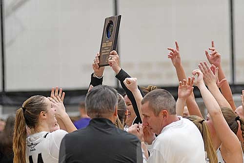 Melissa Ouimette holds up the regional championship plaque after the Thunderbirds defeated Mosinee 66-40 in a WIAA Division 2 regional final game Saturday, March 1 at Ted Voigt Court in Minocqua. The Thunderbirds have won four straight regional titles. (Photo by Brett LaBore/Lakeland Times)