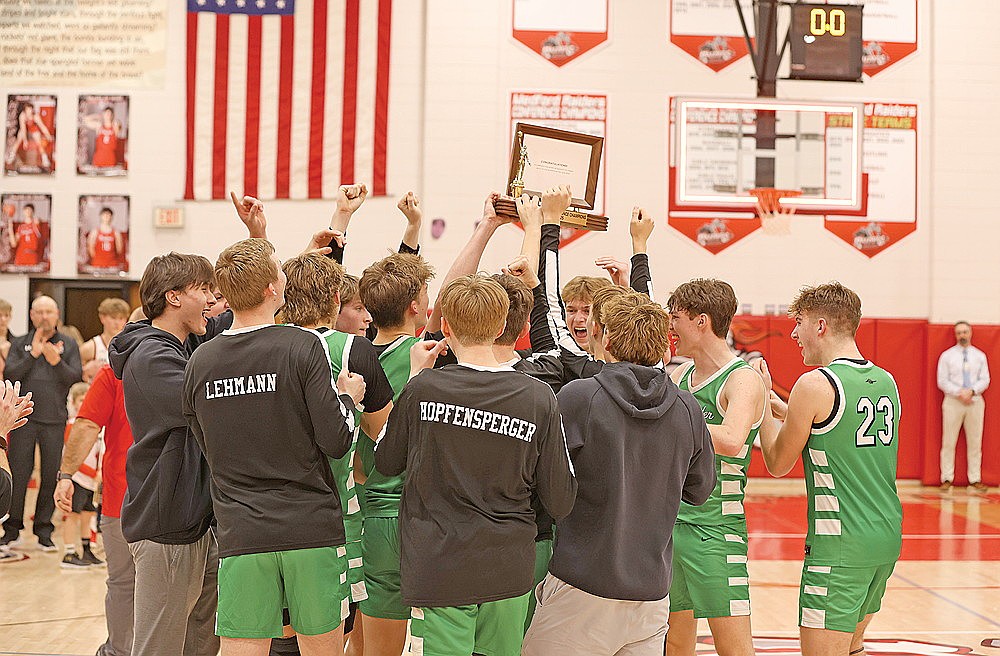 The Rhinelander High School boys’ basketball team raises the Great Northern Conference championship trophy after defeating Medford 51-43 in a de facto GNC title game in Medford Thursday, Feb. 27. Rhinelander won the GNC for a second consecutive year and the seventh time overall. (Bob Mainhardt for the River News)
