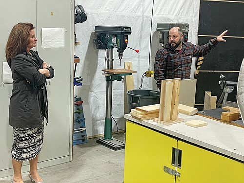 MHLT school board president Christy Seidel listens as MHLT building and grounds director Brad Strasburg points to an area of the technical education room during the March 10 school board meeting. (Photo by Brian Jopek/Lakeland Times)