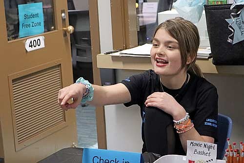 Bella Wildenberg hands out gift basket tickets during the STAR Open house on Tuesday, March 11, at the Lakeland Star School/Academy in Minocqua. (Photo by Kate Reichl/Lakeland Times)