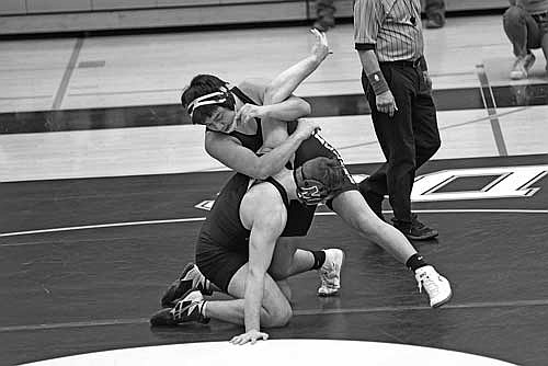 In this Jan. 30, 2025 file photo, Kenny Thompson, top, grabs the arm of Mosinee’s Bruce Hintz in the 190-pound weight class during a conference quad at the Lakeland Union High School fieldhouse in Minocqua. (Photo by Brett LaBore/Lakeland Times)