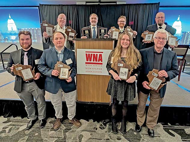 The staff of The Lakeland Times show off a few of their 32 awards at the 2024 WNA Convention on Friday, March 7, at the Madison Concourse Hotel in downtown Madison. Top row, from left, is Dean Hall, Gregg Walker, Brett LaBore and Brian Jopek. Bottom row, Mikey Rottier, Trevor Greene, Kate Reichl and Richard Moore. (Contributed photograph)