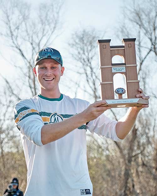 Adam Hammes holds up the trophy after winning the Waco Annual Charity Open Sunday, March 16 in Waco, Texas. Hammes shot 30-under over the three-day tournament. (Photo courtesy of the Disc Golf Pro Tour)