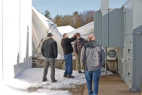 Aegis insurance representative Jim Bradfish photographs parts of the Hodag Dome as Pat Kegley of building and grounds, left, Jerry McKenzie of maintenance, and Robert Thom, business manager, right, look on during a visit on Friday, April 4, in Rhinelander. (Photo by Bob Mainhardt/Northwoods River News)