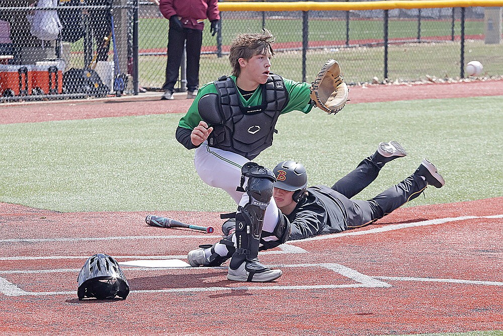 Rhinelander catcher Josh Willoughby attempts to field a throw and put a tag on Barron’s Bryce Kittleson during a non-conference baseball game in Mauston Saturday, April 6. (Jeremy Mayo/River News)