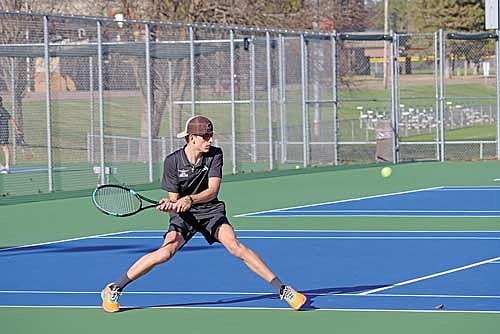 Angus Callender goes to make a play on the ball in his No. 2 doubles match against Pacelli Tuesday, April 29 at the Lakeland Union High School tennis courts in Minocqua. (Photo by Kate Reichl/Lakeland Times)