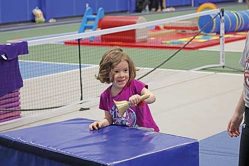 Three-year-old Finnley Koster rings a bell after finishing the obstacle course at Healthy Kids Day on Saturday, April 26, at the YMCA of the Northwoods in Rhinelander. (Photo by Kate Reichl/Lakeland Times)