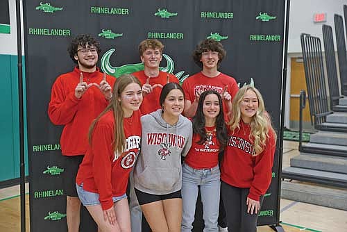 On Wisconsin! Seven Rhinelander High School seniors who plan to attend the University of Wisconsin-Madison next fall pose for a photograph following Rhinelander High School Senior Signing Day at the Jim Miazga Community Gymnasium Thursday, May 1. Pictured in the front row, from left to right, are Ellyse Younker, Luna Grage, Brynn Teter and Evelyn Sawyer. In the back row are Samson Shinners, Seth Nofftz and John Turek. RHS senior Julia Gray, who will also become a Badger this fall, was unavailable for the photograph. (Photo by Bob Mainhardt for the River News)