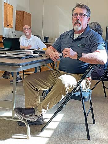 While Pelican town chairman Nick Scholtes, left, listens, Mark Barden of Town and Country Engineering answers questions related to a proposed water well project between the city of Rhinelander and Nicolet College during the May 5 meeting of the Pelican town board. (Photo by Brian Jopek/Lakeland Times)