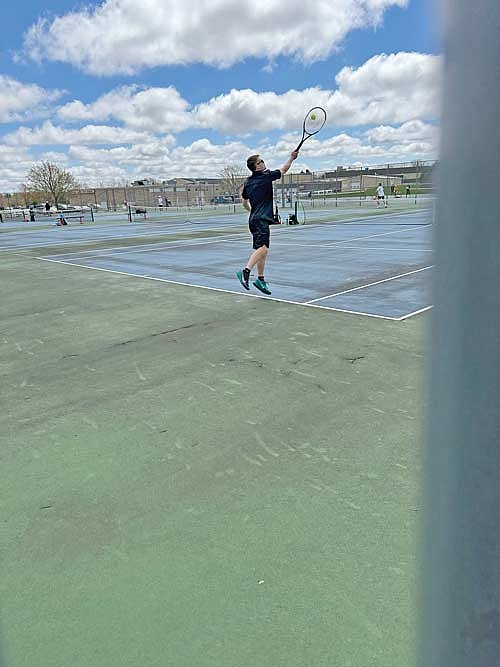 Sawyer Brown serves the ball in his No. 4 singles match during the Washington County Invite Saturday, May 3 at Slinger High School. (Contributed photograph)