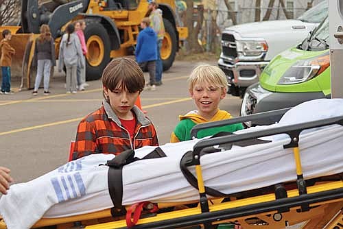 Fourth-grade students Dametri Watson, left, and Ryan Jopek learn about ambulances during Careers on Wheels on Thursday, May 1, at Nativity Catholic School in Rhinelander. (Photo by Kate Reichl/Lakeland Times)