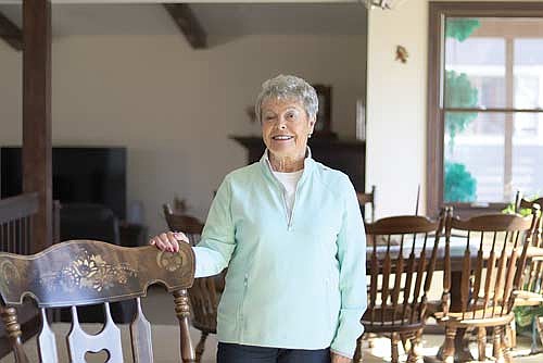 Dianna Lang relaxes in her remodeled 1935 Minocqua island home. Lang was raised in downtown Minocqua and has helped visitors and community members alike at the Minocqua Visitor’s Bureau for 27 years. (Photo by Michael Strasburg/Lakeland Times)