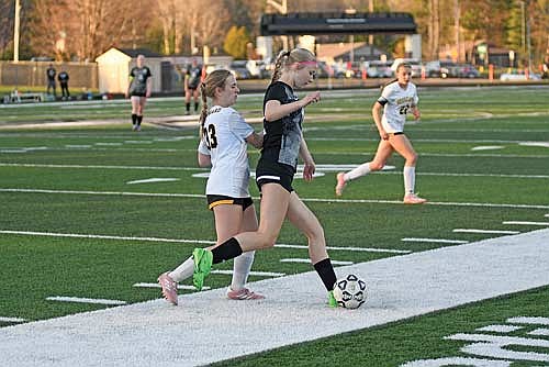 Kasey Wise shields off Hayward’s Julianna Lawrence while possessing the ball in the first half Thursday, May 8 at IncredibleBank Field in Minocqua. (Photo by Brett LaBore/Lakeland Times)