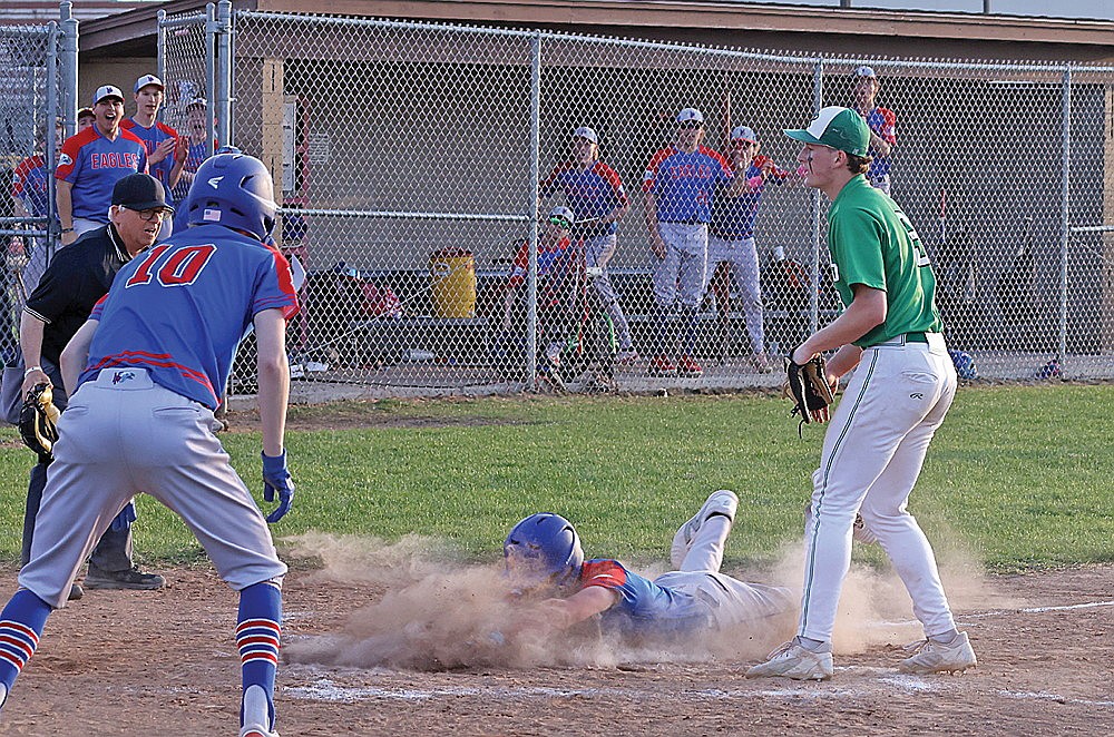 Northland Pines’ Brody Hoeft slides home in front of Rhinelander pitcher Dylan Vanderbunt to score the winning run in the 10th inning of a GNC baseball game in Eagle River Friday, May 9. The Eagles won 2-1, handing the Hodags their third one-run loss in their last four games. (Bob Mainhardt for the River News)
