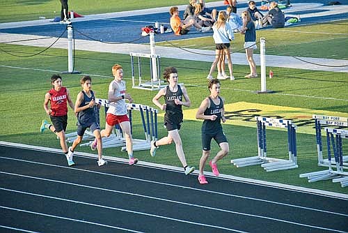 Parker McKinney leads Barrett Eggen in the 3,200-meter run during the DeMerit Invite Friday, May 9 at Bay Port High School. McKinney and Eggen both finished with personal records. Photo courtesy of Azael Meza. (Contributed photograph)