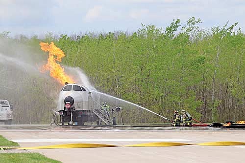 Rhinelander firefighters try to extinguish a fuselage fire during a mock aircraft disaster exercise at the Rhinelander Airport on May 14. (Photo by Michael Strasburg/Lakeland Times)