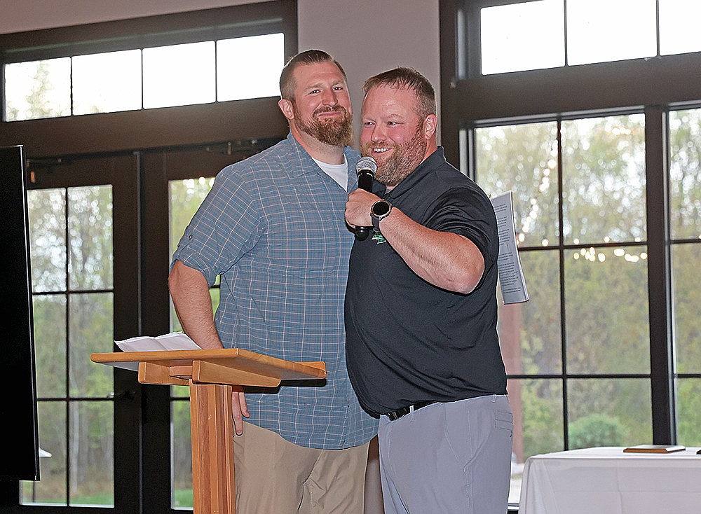Tyler Johnson, left, hugs his brother Kevin Johnson at the podium during the 43rd annual Rhinelander Athletic Booster Club Banquet at the Pines Events Center Wednesday, May 14. Tyler Johnson, a football standout and RHS Class of 2005 graduate, was inducted into the ABC’s Hodag Hall of Fame. Kevin Johnson delivered the presenting speech. (Bob Mainhardt for the River News)