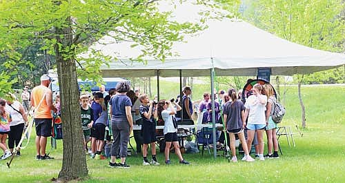 One of the stations at MOHEE got kids into learning about birds and amphibians, giving them a chance to check out some birds with binoculars as well as to handle amphibians such as turtles. (Photo by Beckie Gaskill/Lakeland Times)