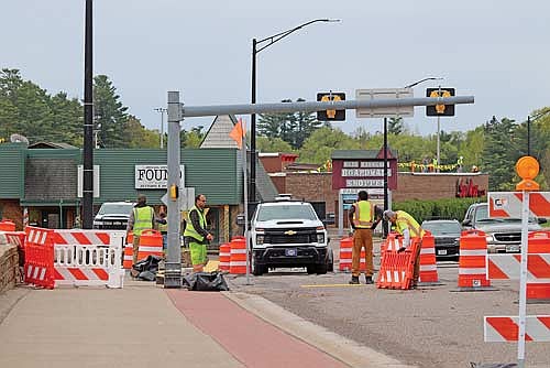 A road construction crew breaks down curb-ramp barriers on Wednesday morning. (Photo by Michael Strasburg/Lakeland Times)