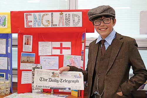 Sixth-grader Noah Kemnitz represents jolly old England at the MHLT Cultural Fair on May 27. In preparation for the fair, students spent a month researching their chosen country’s geography, culture and politics while also developing a dish to serve. Students discussed their country and answered questions with staff and visitors Wednesday afternoon. (Photo by Michael Strasburg/Lakeland Times)