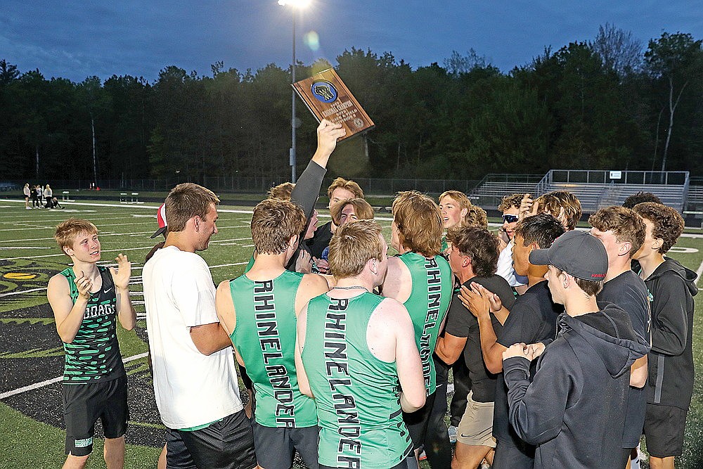 The Rhinelander High School boys’ track team celebrates with the championship plaque following a WIAA Division 2 regional at Mike Webster Stadium Tuesday, May 27. The Hodag boys advanced 12 entries to today’s sectional round in Durand. (Bob Mainhardt for the River News)
