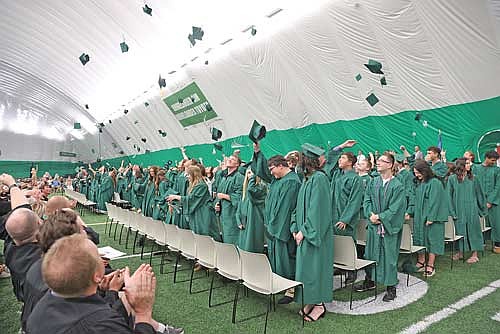 Members of the Rhinelander High School Class of 2025 toss their caps in the air after being confirmed as graduates during commencement exercises in the Hodag Dome Sunday, June 1. The event serves as the first public event in the dome since March 29, a day before it received significant damage as the result of a power outages created by an ice storm. (Photo by Bob Mainhardt for the River News)