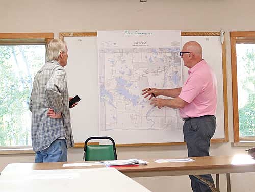 Mike Pazdernik, left, and David Holperin discuss zoning in the town of Crescent at last week’s plan commission meeting. (Photo by Beckie Gaskill/Lakeland Times)