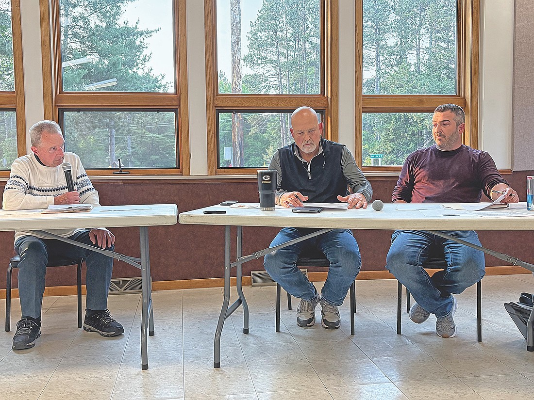 The town board, from left, town chairman John Hanson, town supervisor Lynn Schroeder and town supervisor Doug Zeise, discuss an enhanced wake ordinance during a meeting on Tuesday, June 10, in Manitowish Waters. (Photo by Trevor Greene/Lakeland Times)
