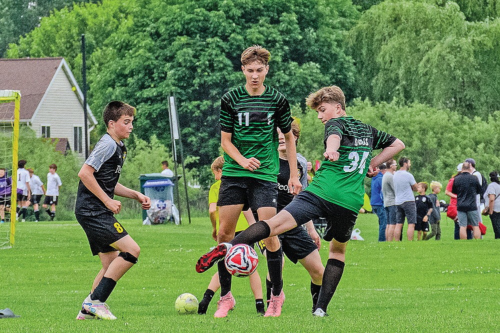 Hunter Choinski looks to play the ball as teammate Kamden Kostrova (11) looks on.